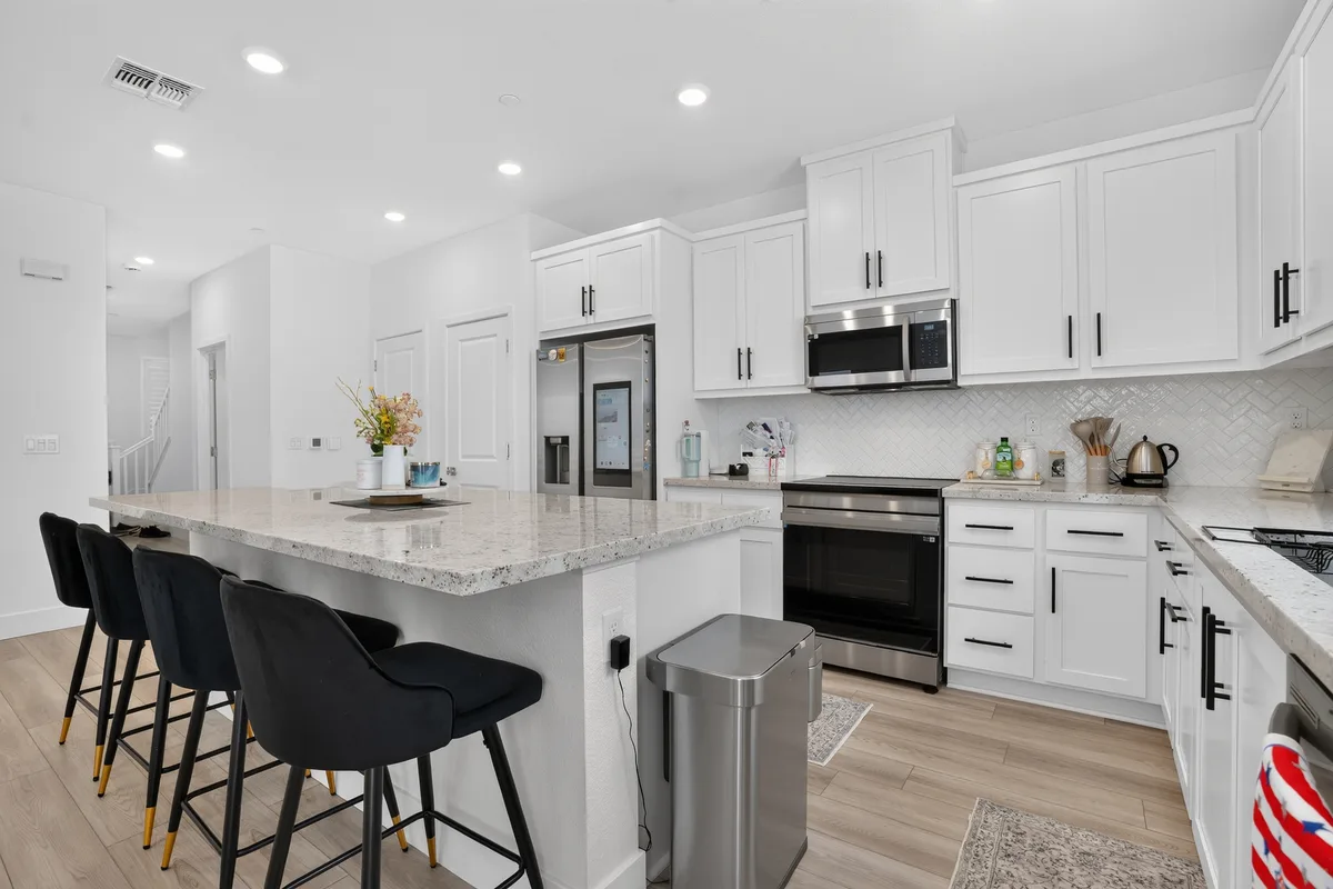 A freshly renovated white kitchen staged and ready to be shown to buyers