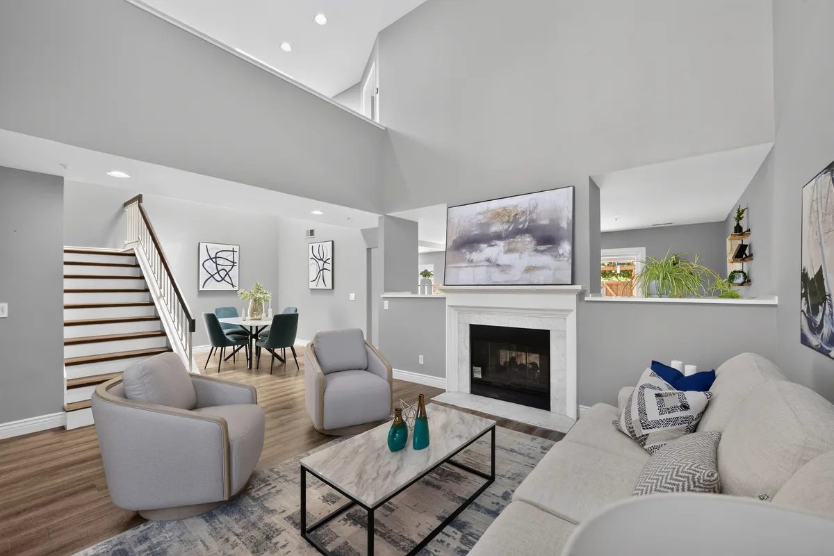 A staged living room with a fireplace and vaulted ceiling, the kind of finished result an AI-coordinated prep workflow would aim for