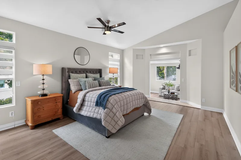 Bedroom with upholstered headboard and hardwood floors
