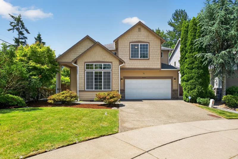 Front exterior of a two-story home with a two-car garage, a typical vacant listing being prepped for sale