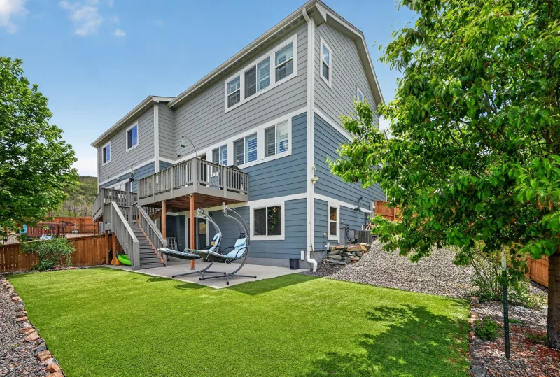 Empty backyard patio of a vacant two-story home